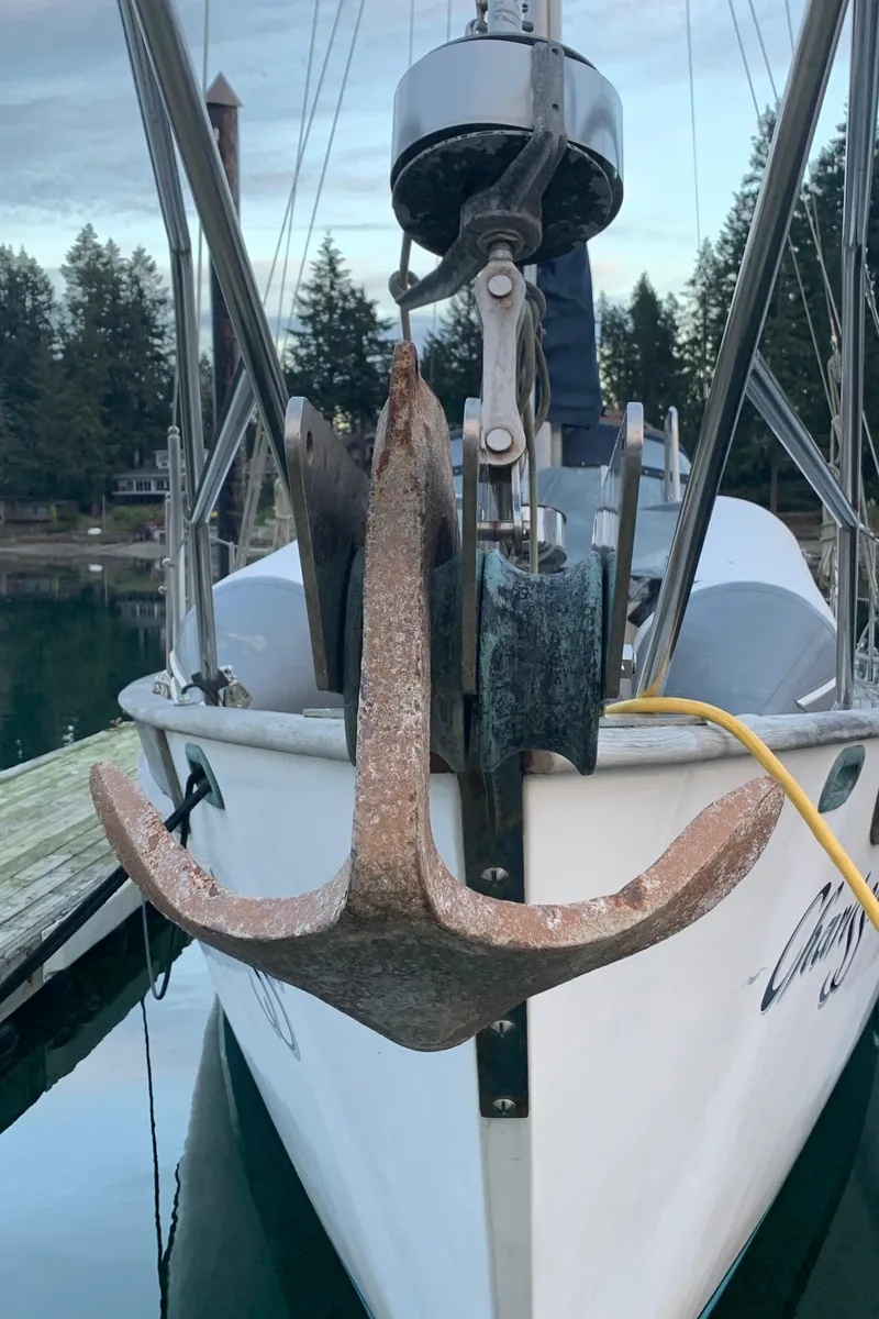 Slide: The Image of 1983 Liberty Center Cockpit sailboat with anchor, docked in a serene marina setting. - 5
