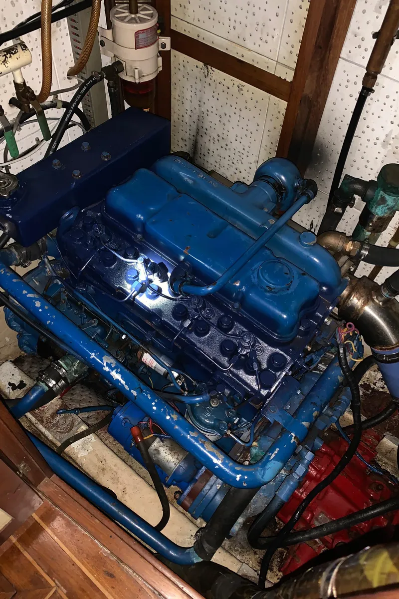 Slide: The Image of Engine of a 1983 Liberty Center Cockpit boat, featuring a blue-painted motor. - 6