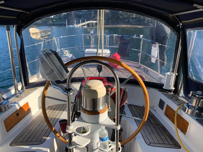 Slide: The Image of 1983 Liberty Center Cockpit sailboat interior with wooden steering wheel and nautical equipment. - 9