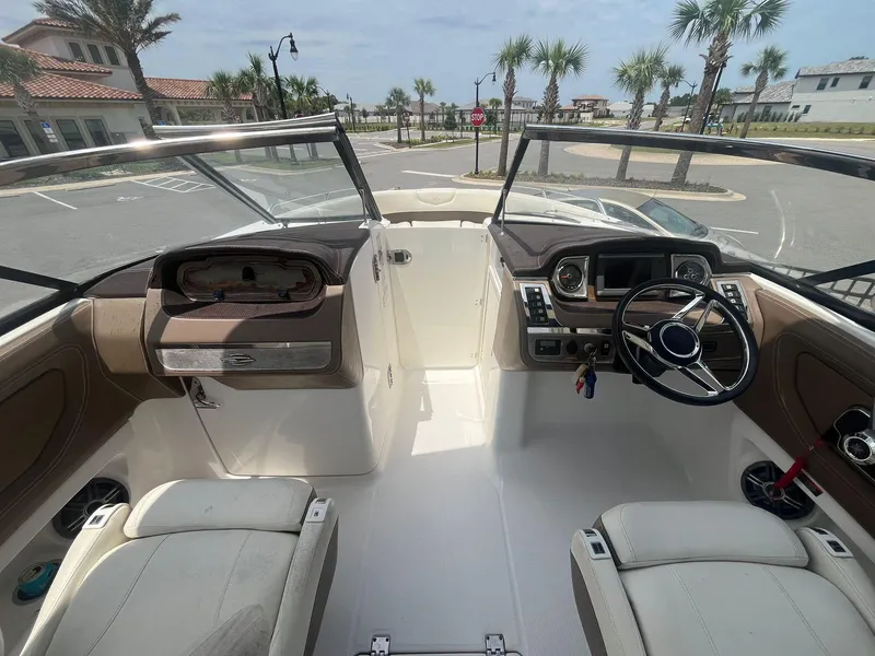 Slide: The Image of 2013 Chaparral 257 SSX boat interior with dual seats and steering console. - 21