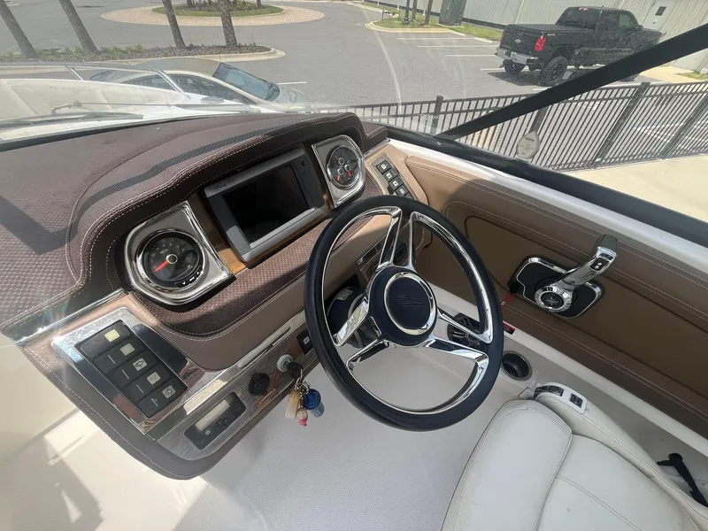 Slide: The Image of Interior view of 2013 Chaparral 257 SSX boat dashboard with steering wheel and controls. - 22