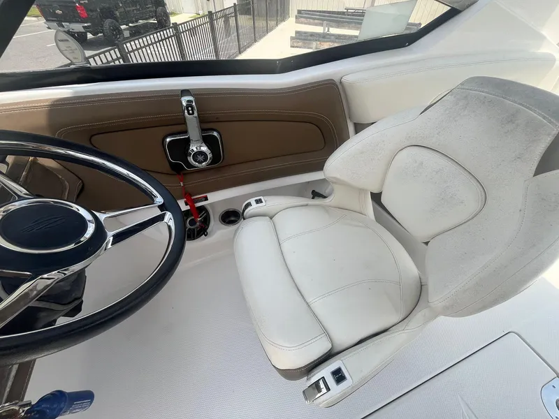 Slide: The Image of Captain's seat and steering wheel of 2013 Chaparral 257 SSX boat interior. - 23