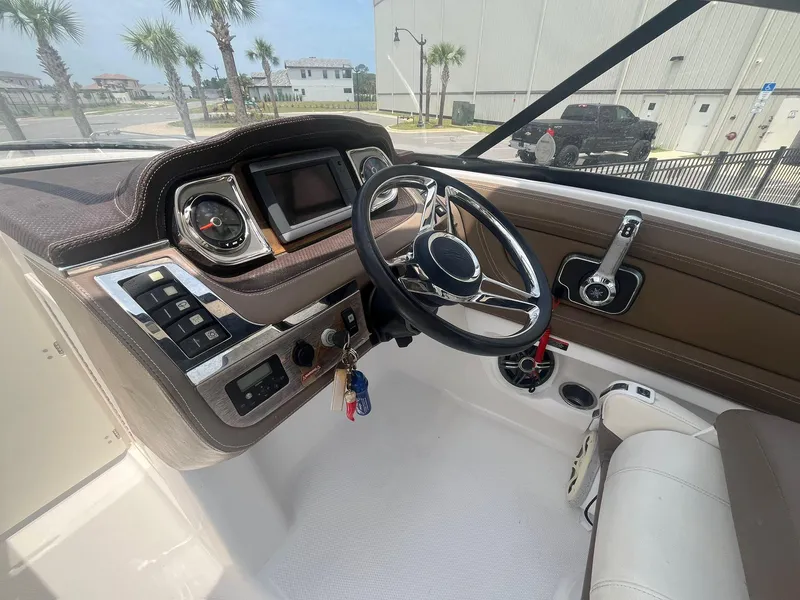 Slide: The Image of 2013 Chaparral 257 SSX boat interior with steering wheel and control panel. - 26