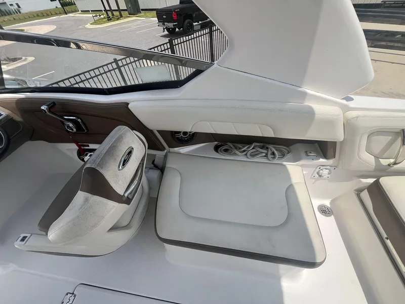 Slide: The Image of 2013 Chaparral 257 SSX boat interior with seating and storage compartment. - 28