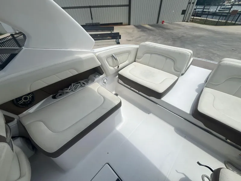 Slide: The Image of 2013 Chaparral 257 SSX boat interior with white cushioned seating. - 31