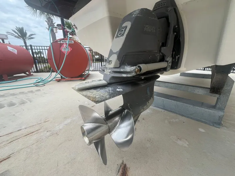 Slide: The Image of 2013 Chaparral 257 SSX boat propeller and stern drive, displayed on a concrete surface. - 37