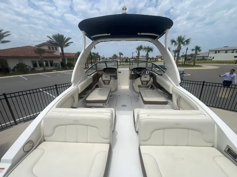 Slide: The Image of 2013 Chaparral 257 SSX boat with spacious seating and sleek design, docked outdoors. - 40