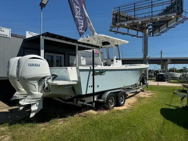 Slide: The Image of 2025 Parker 2600 Center Console boat with Yamaha engine on trailer, displayed outdoors. - 0