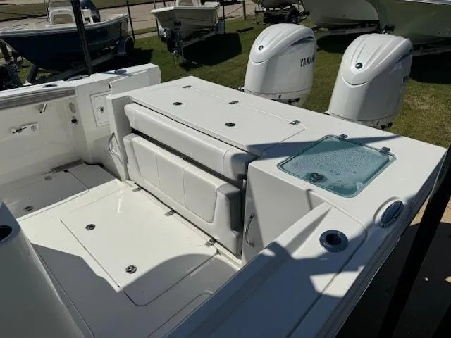 Slide: The Image of 2025 Parker 2600 Center Console boat interior with Yamaha engines, featuring seating and storage. - 2