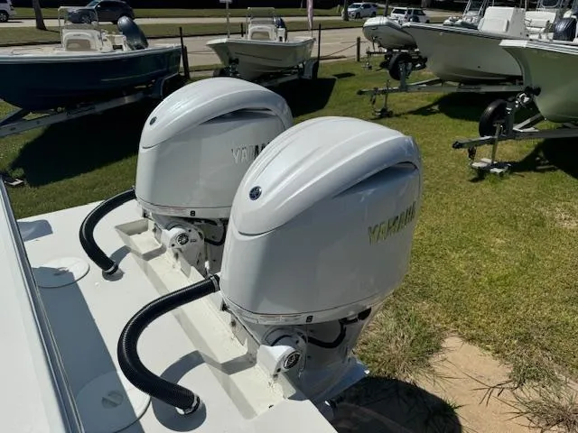 Slide: The Image of Twin outboard motors on a 2025 Parker 2600 Center Console boat, displayed outdoors. - 5