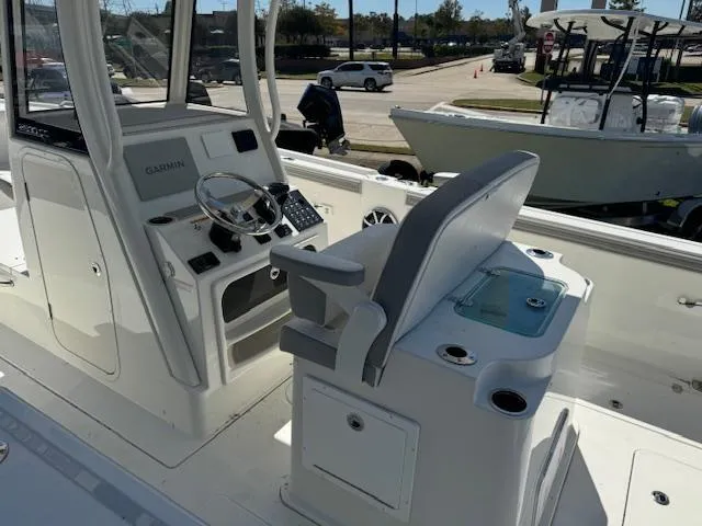 Slide: The Image of 2025 Parker 2600 Center Console boat interior with steering wheel and seating. - 6