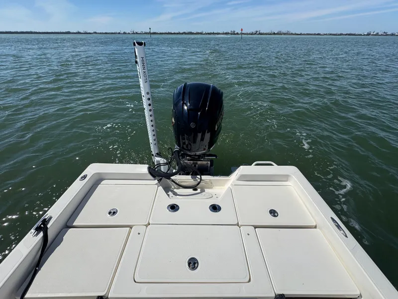 Slide: The Image of 2022 Skeeter SX230 boat on water, rear view with motor and calm sea. - 16