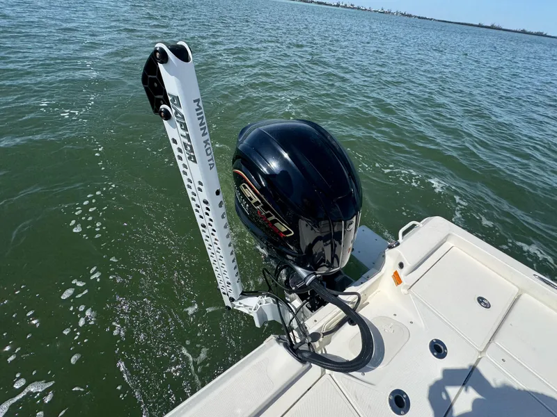 Slide: The Image of 2022 Skeeter SX230 boat with Minn Kota motor on calm water. - 17