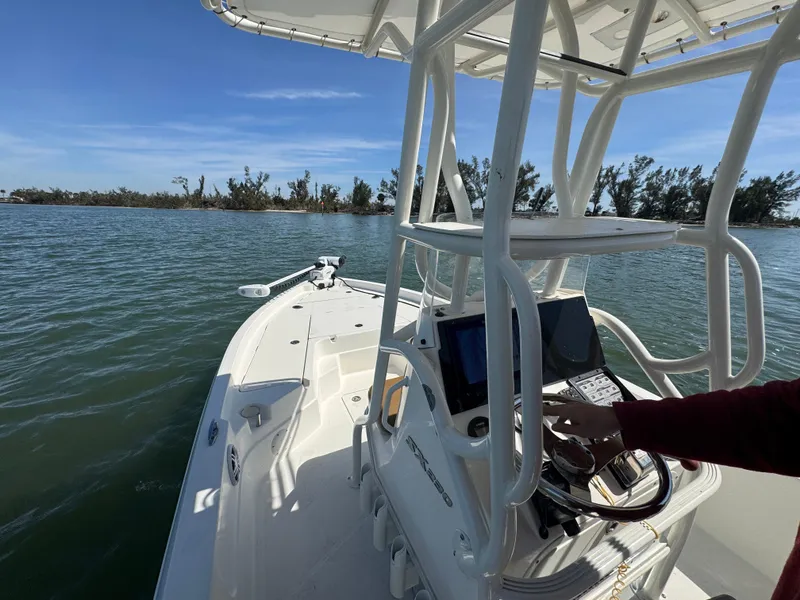 Slide: The Image of 2022 Skeeter SX230 boat on water, featuring a modern console and clear blue sky. - 20