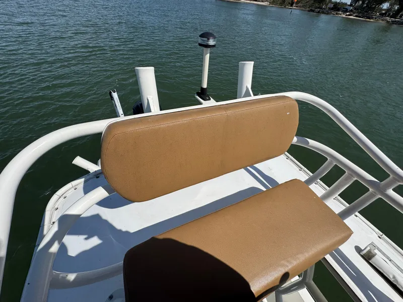 Slide: The Image of 2022 Skeeter SX230 boat with tan seating, on calm water. - 25