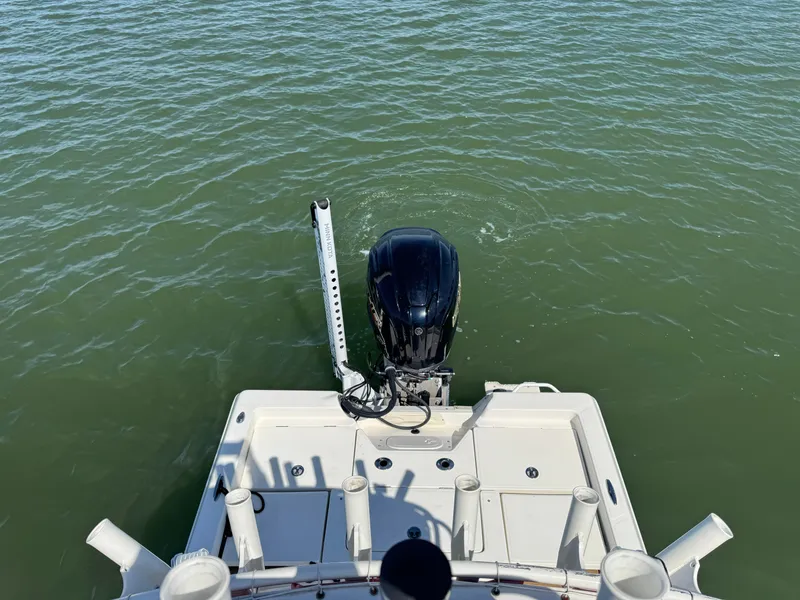 Slide: The Image of 2022 Skeeter SX230 boat with outboard motor on calm water. - 26