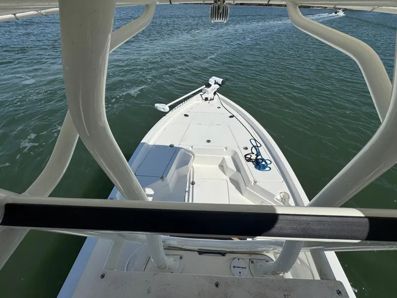 Slide: The Image of 2022 Skeeter SX230 boat on water, viewed from above, showcasing deck and railing. - 27