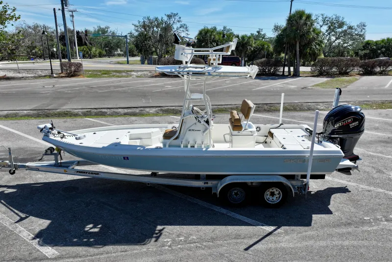 Slide: The Image of 2022 Skeeter SX230 boat on trailer in parking lot, side view. - 7
