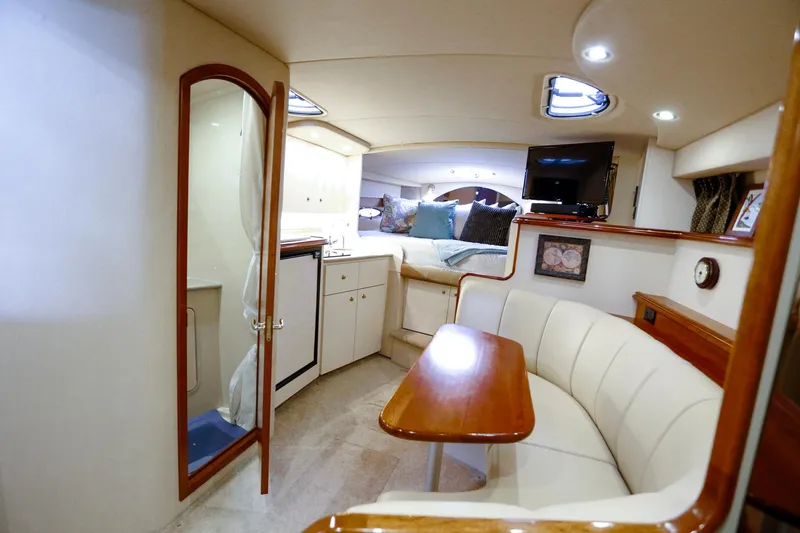 Slide: The Image of Interior of 2003 Cruisers Yachts 3275 Express, featuring cozy seating and modern amenities. - 25