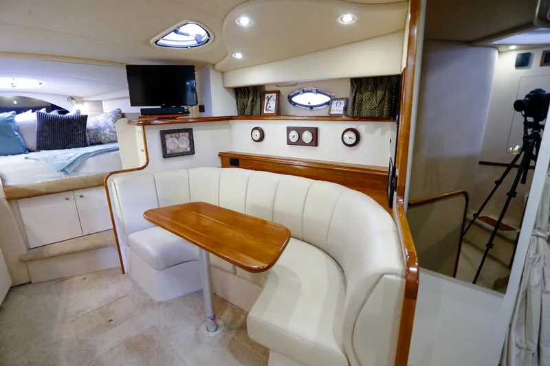Slide: The Image of Interior of 2003 Cruisers Yachts 3275 Express with cozy seating and elegant wood finishes. - 26