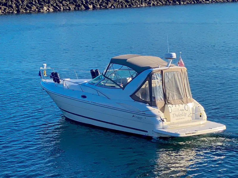 Slide: The Image of 2003 Cruisers Yachts 3275 Express on calm water, rear view with canopy. - 3