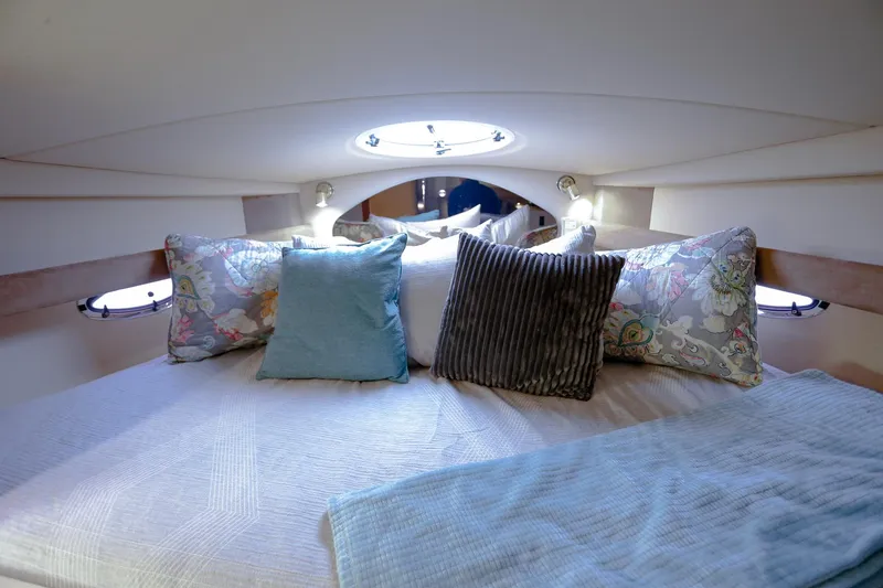 Slide: The Image of Luxurious cabin interior of 2003 Cruisers Yachts 3275 Express with plush pillows and soft lighting. - 31