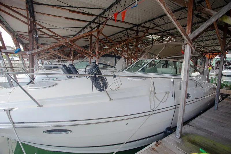 Slide: The Image of 2003 Cruisers Yachts 3275 Express docked in a covered marina. - 33