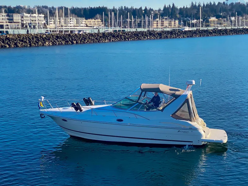 Slide: The Image of 2003 Cruisers Yachts 3275 Express on calm water near marina. - 5