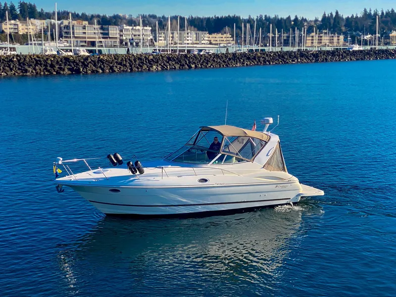 Slide: The Image of 2003 Cruisers Yachts 3275 Express on calm water near marina. - 6