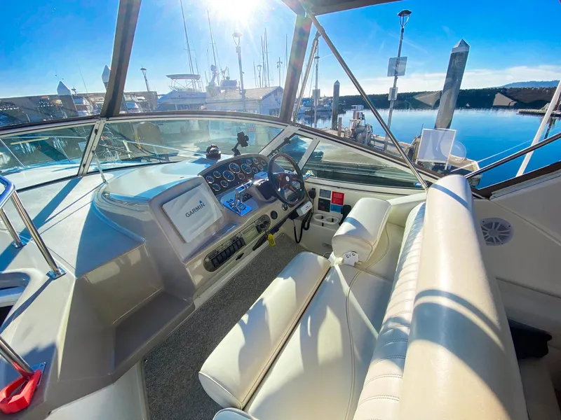 Slide: The Image of 2003 Cruisers Yachts 3275 Express helm with Garmin navigation, docked in sunny marina. - 15