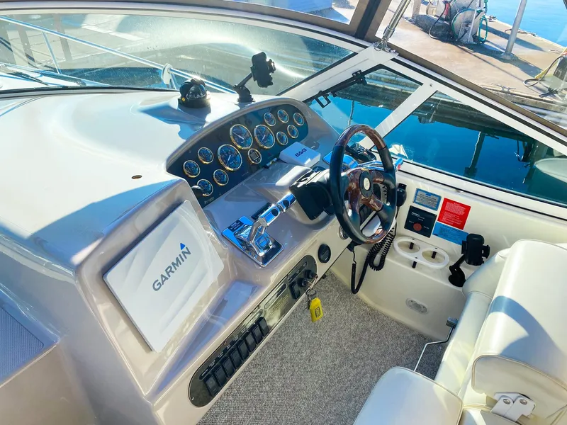 Slide: The Image of 2003 Cruisers Yachts 3275 Express helm with Garmin navigation system and steering wheel. - 16