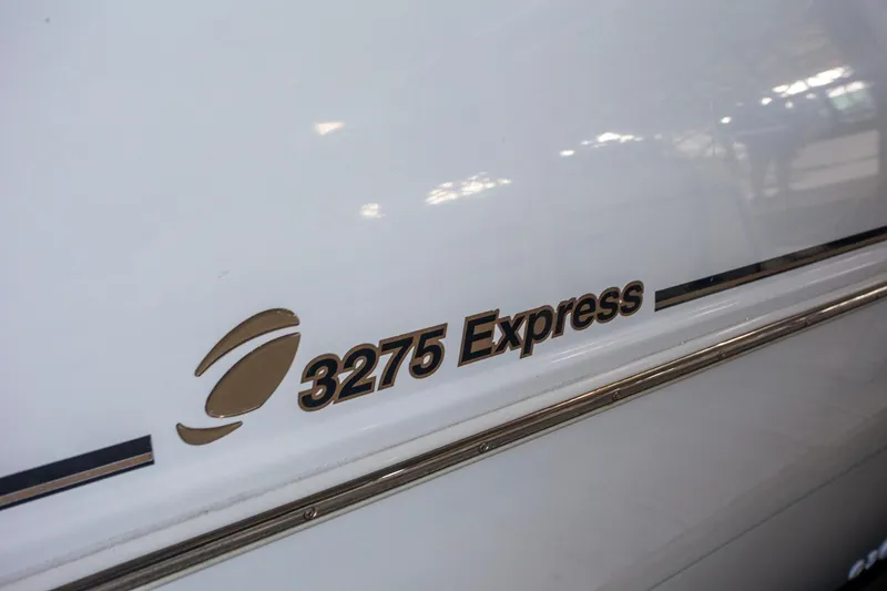 Slide: The Image of 2003 Cruisers Yachts 3275 Express logo on white boat exterior. - 18