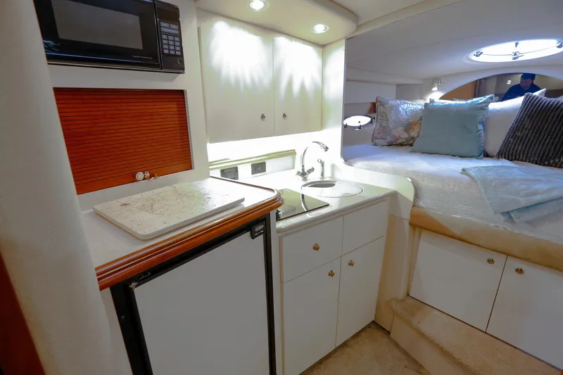 Slide: The Image of Interior of 2003 Cruisers Yachts 3275 Express with kitchenette and cozy sleeping area. - 27