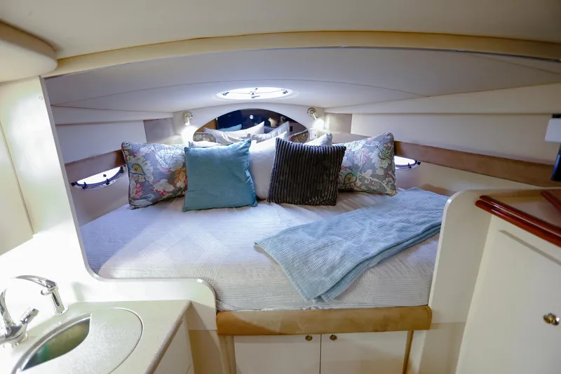 Slide: The Image of Luxurious cabin interior of 2003 Cruisers Yachts 3275 Express with cozy bedding and elegant decor. - 28
