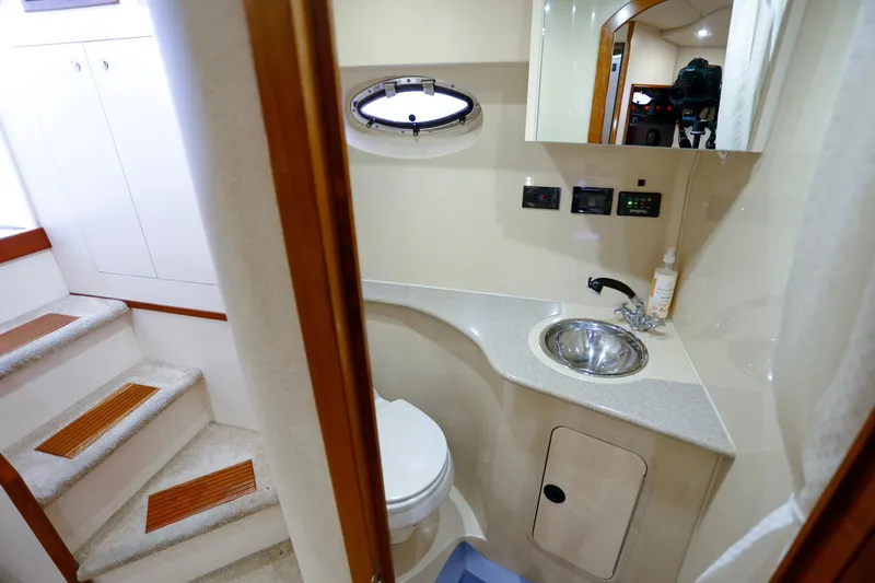 Slide: The Image of 2003 Cruisers Yachts 3275 Express bathroom with sink, toilet, and mirror. - 32
