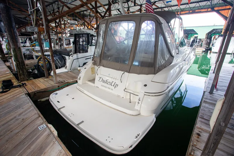 Slide: The Image of 2003 Cruisers Yachts 3275 Express docked in a marina, rear view. - 35