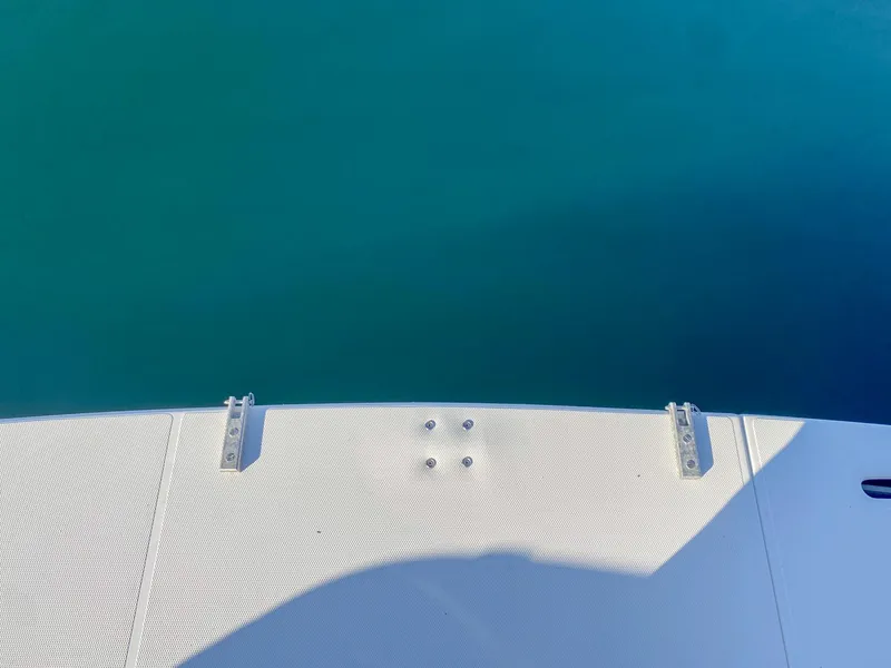 Slide: The Image of 2003 Cruisers Yachts 3275 Express swim platform above clear blue water. - 9