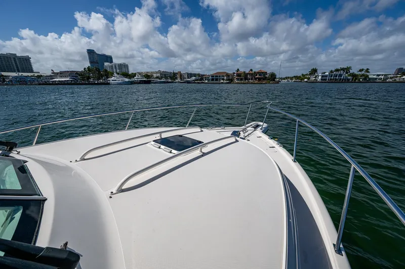 Slide: The Image of 2014 Pursuit 345os boat on water with city skyline in background. - 19