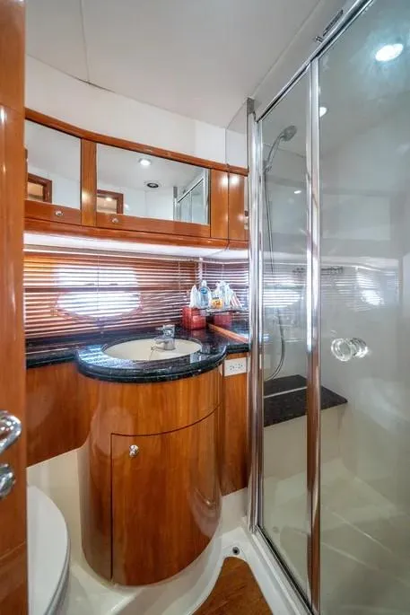 Slide: The Image of Luxurious bathroom in 2006 Sunseeker 64 Manhattan yacht with wood accents and glass shower. - 14