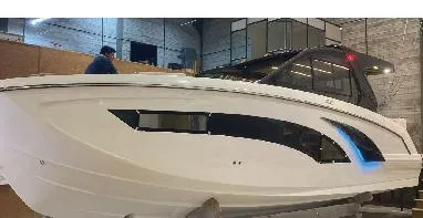 Slide: The Image of 2025 Hanover 387 Outboard Classic Luxury Edition boat in a showroom setting. - 3