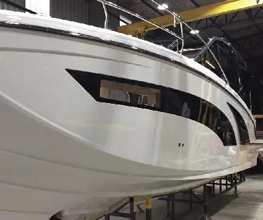 Slide: The Image of 2025 Hanover 387 Outboard Classic Luxury Edition boat in a showroom. - 4