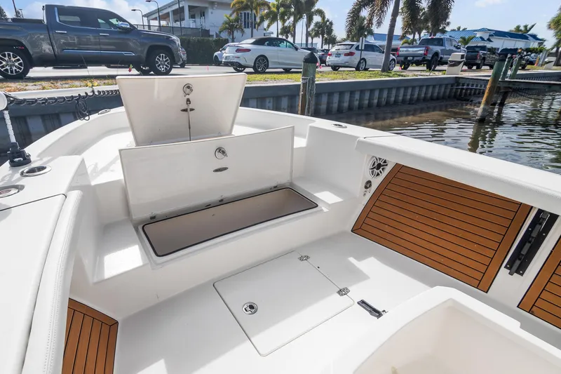 Slide: The Image of 2023 Pathfinder 2700 Open boat interior with storage compartments and wood accents. - 11