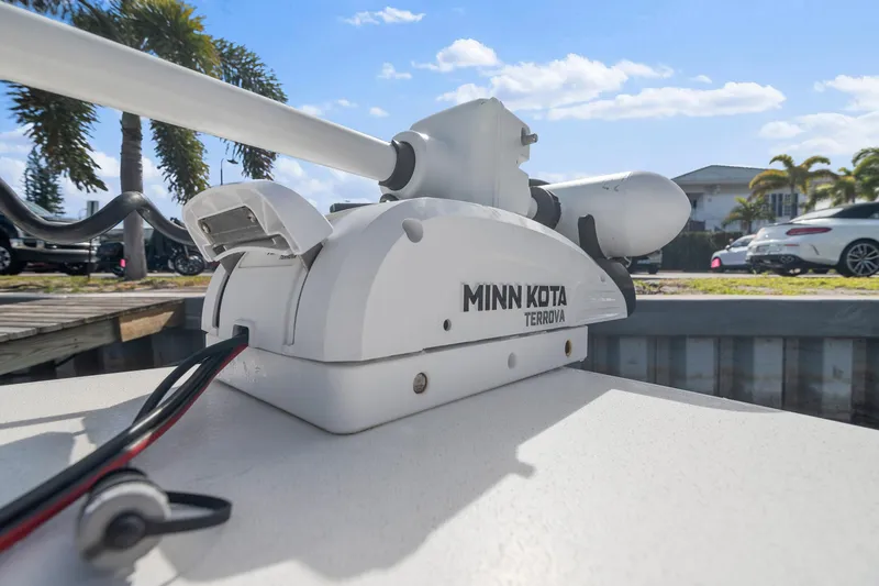 Slide: The Image of Minn Kota Terrova motor on 2023 Pathfinder 2700 Open boat, sunny day, palm trees in background. - 12