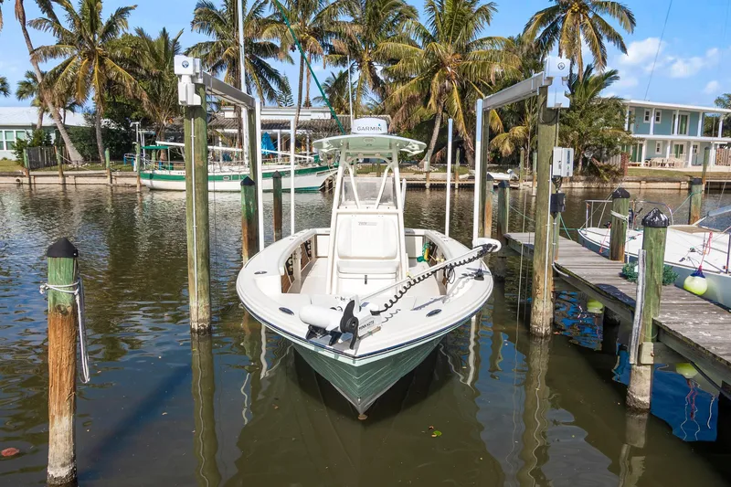 Slide: The Image of 2023 Pathfinder 2700 Open boat docked in a tropical marina setting. - 16