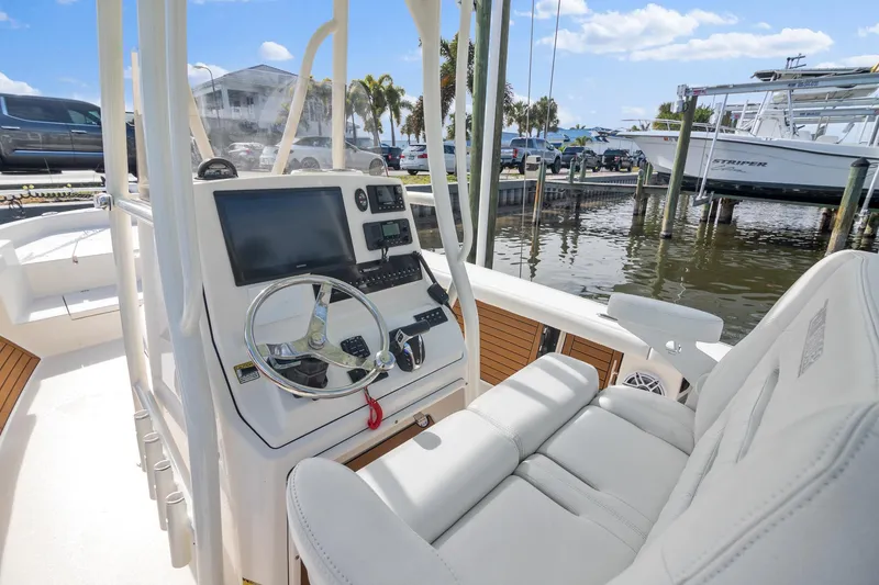 Slide: The Image of 2023 Pathfinder 2700 Open boat interior with steering console, docked at marina. - 5