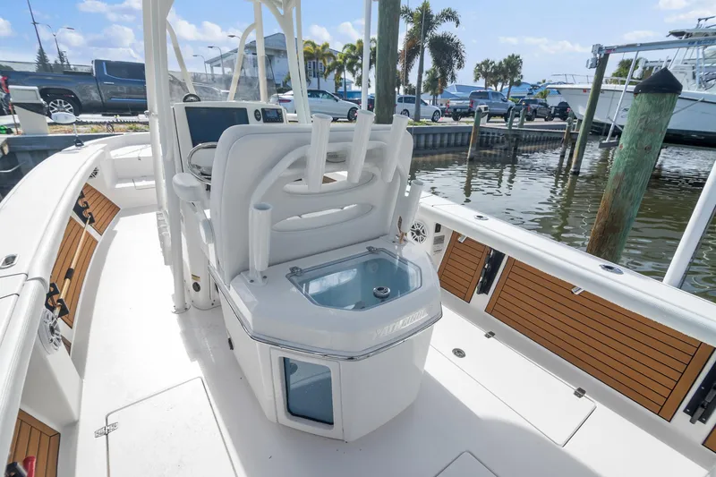 Slide: The Image of 2023 Pathfinder 2700 Open boat interior at marina, featuring seating and storage. - 7