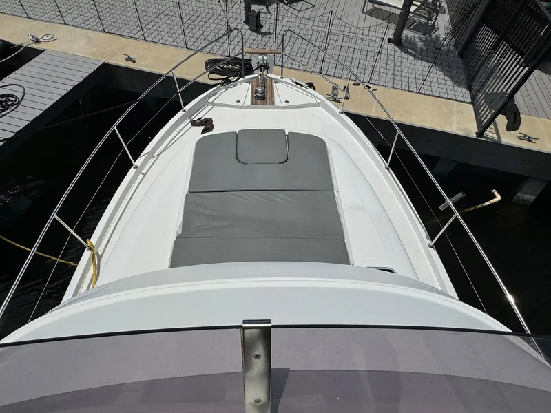 Slide: The Image of 2017 Beneteau Swift Trawler 34, top view of bow with sunpad, docked. - 39