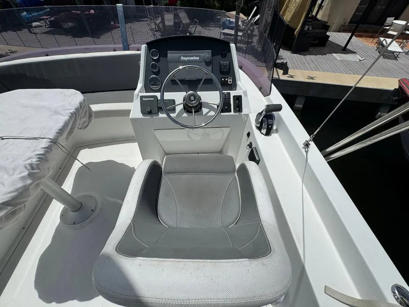 Slide: The Image of 2017 Beneteau Swift Trawler 34 helm with steering wheel and navigation equipment. - 44