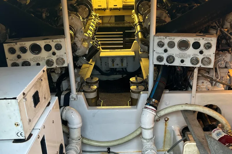 Slide: The Image of Engine room of a 1997 Viking 53 Convertible yacht, showcasing machinery and control panels. - 16