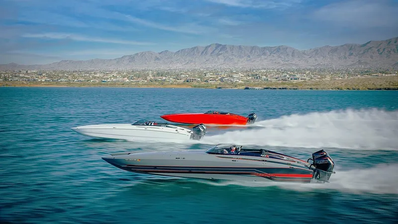 Slide: The Image of 2021 Daves Custom Boats M-37R racing on a scenic lake with mountains in the background. - 10